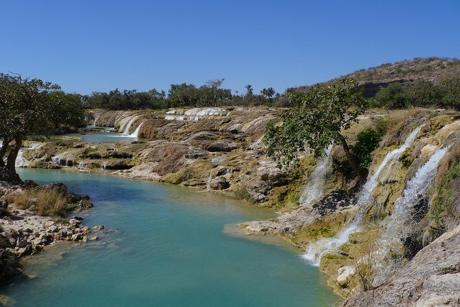 Mountain Tour - Darbat falls, Jebel Samhan, sinkholes, baobabs - Stop 1: Wadi Darbat waterfall walk, camel moments, and a cool river break