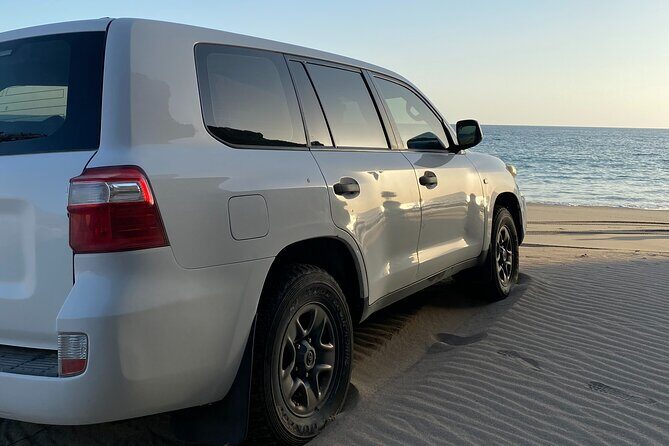 Private Full-Day East Oman Tour from Salalah with Lunch - Taqah Beach: white sand, clear water, and a cliff-side viewpoint